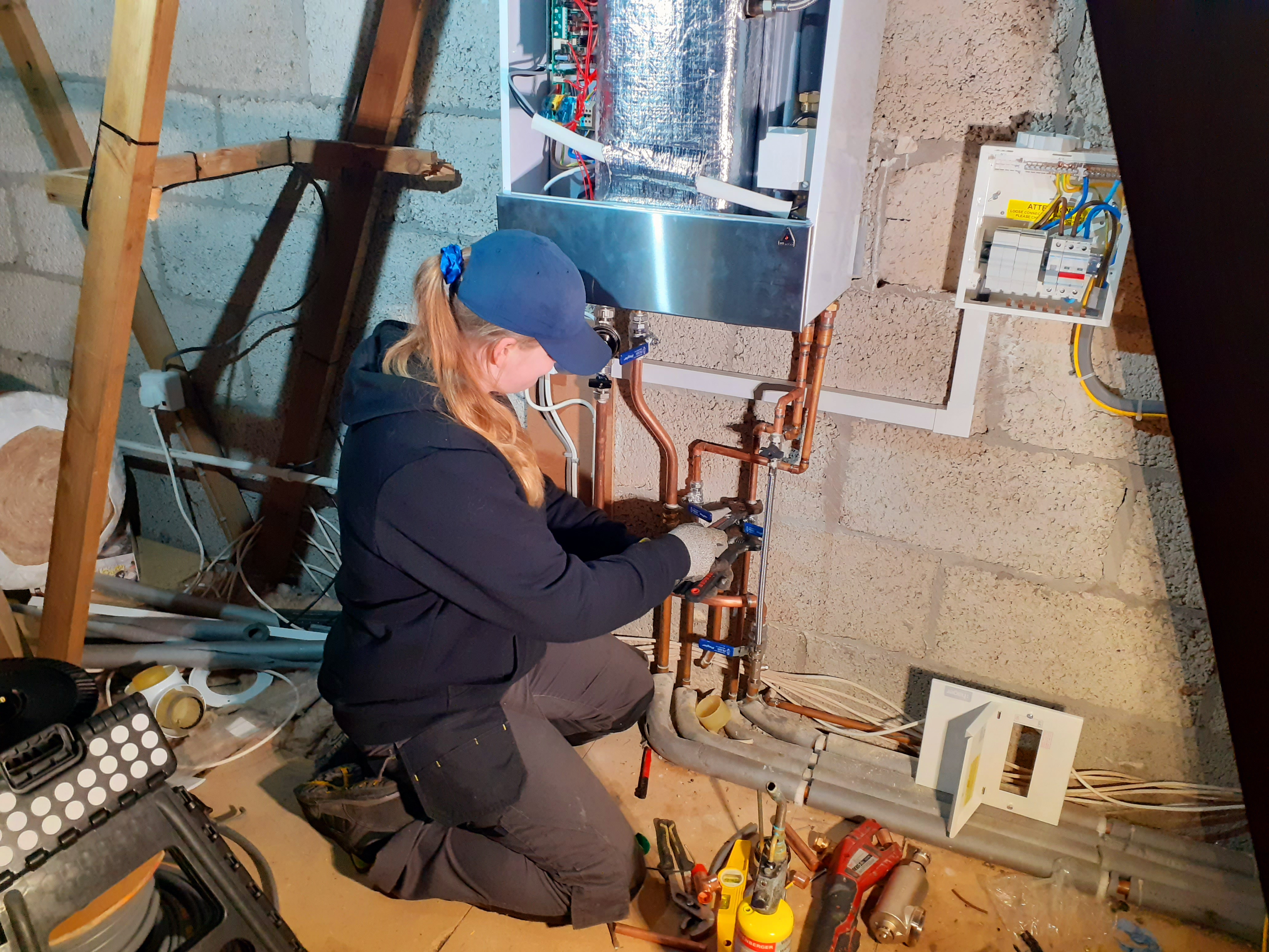 Taneisha De Gruchy installing a boiler