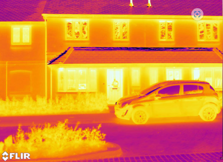 Thermal image of the outside of a house and a car parked at the front