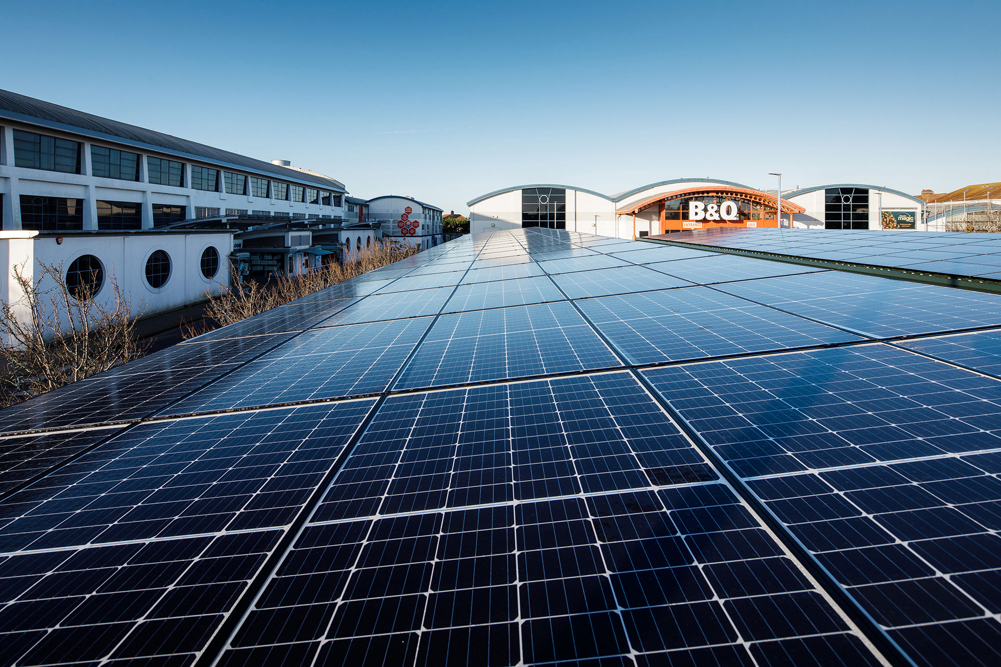 A photograph taken at The Powerhouse site. Solar PV panels in the foreground and B and Q in the distance.