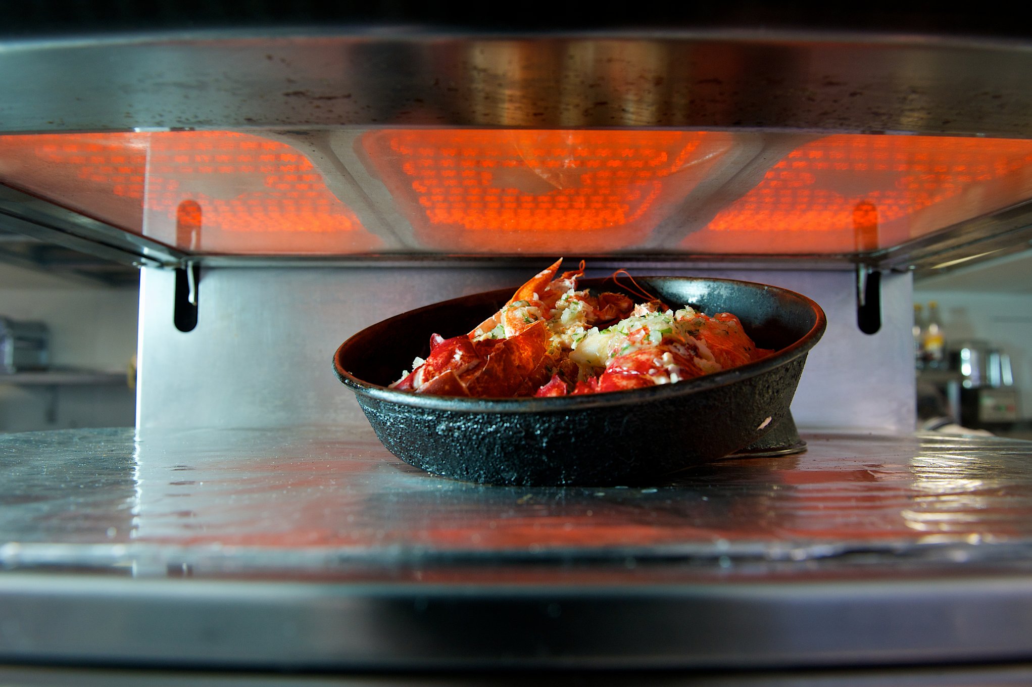 Food cooking under a commercial kitchen grill