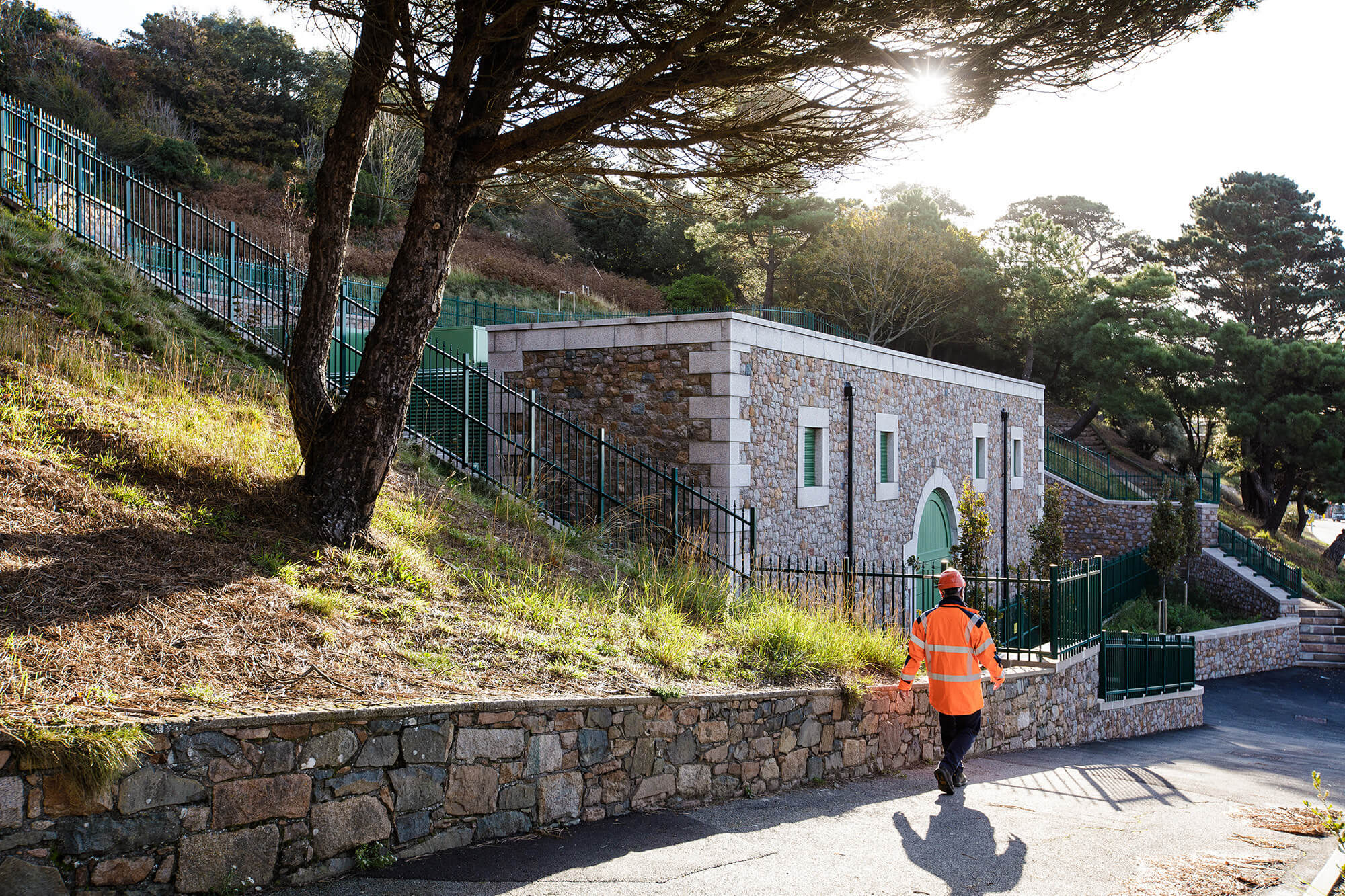 A Jersey Electricity worker walks past the St Helier West substation.