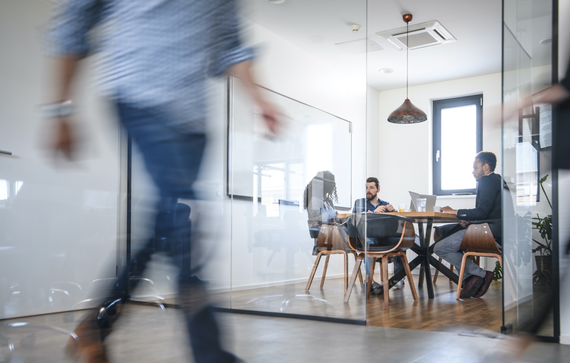 Four people in a meeting in a modern office