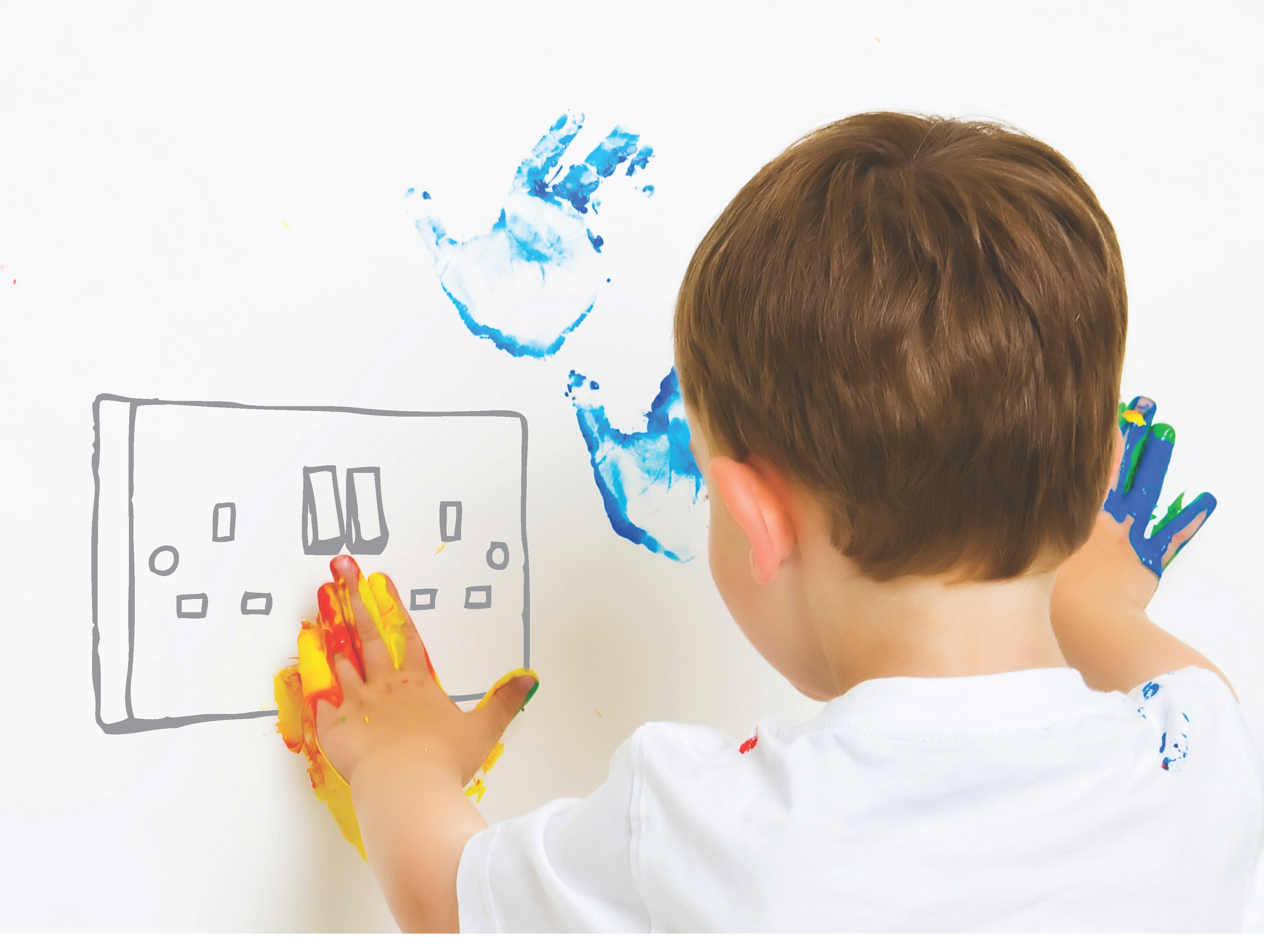 A child with paint on their hands plays with an imaginary power socket