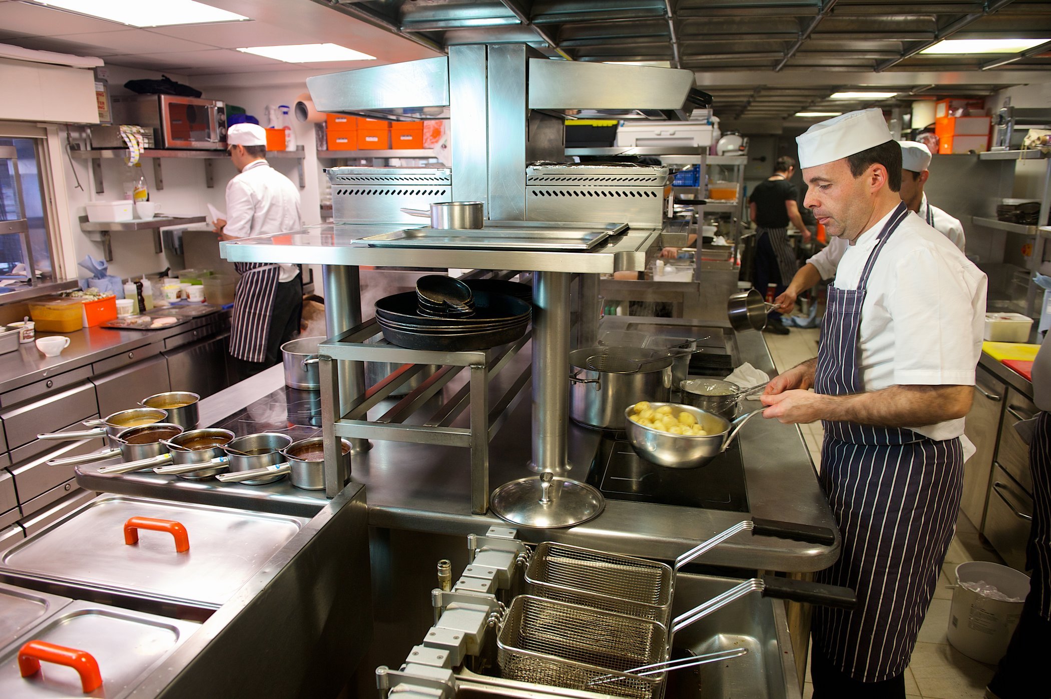 Chefs cooking in a commercial kitchen