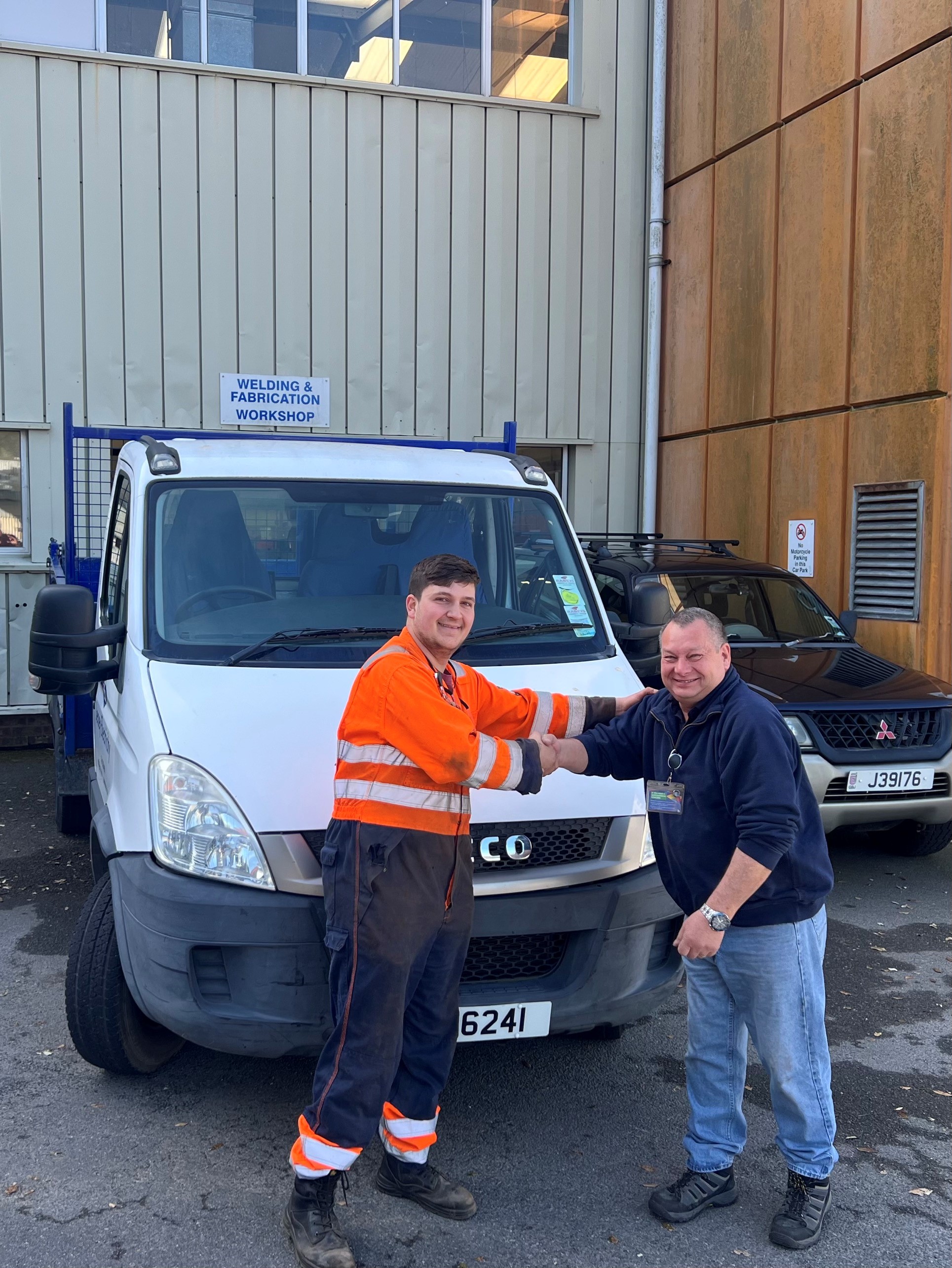 JE Mechanical Craftsperson, Diogo Pereira, shaking hands with Highlands College Workshop technician, John Travert