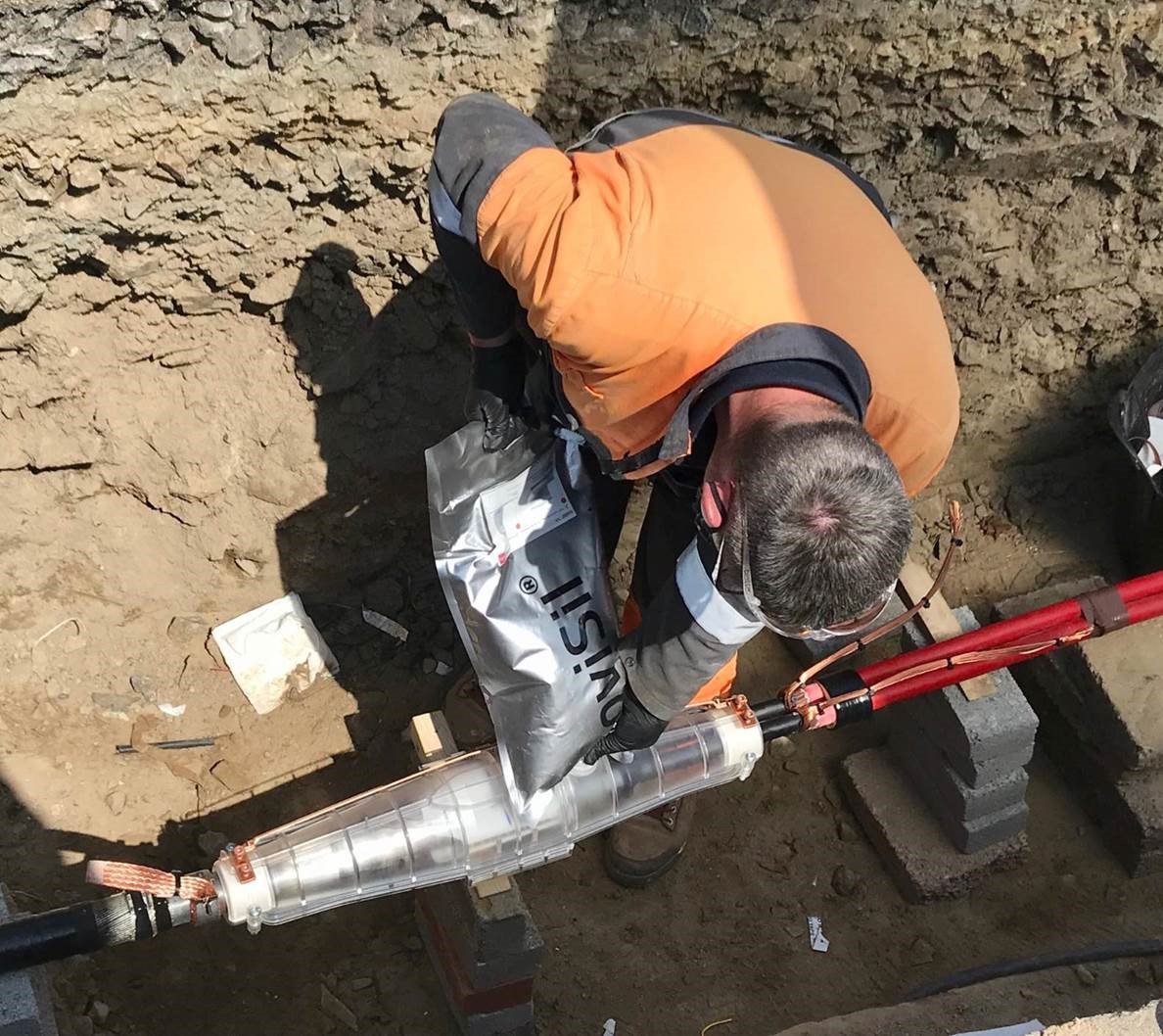 Engineer connects electric cables