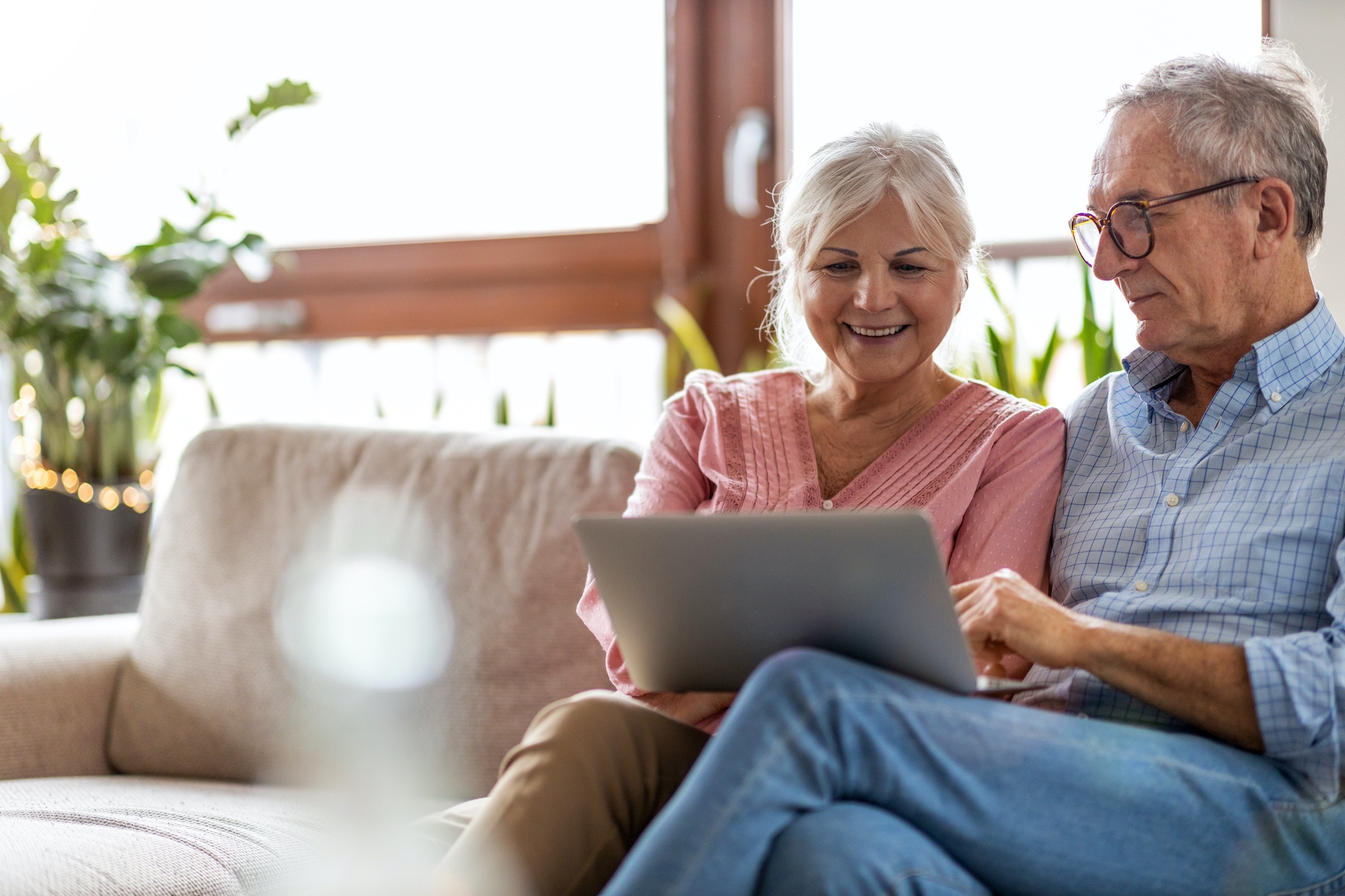 Couple using a laptop on the couch