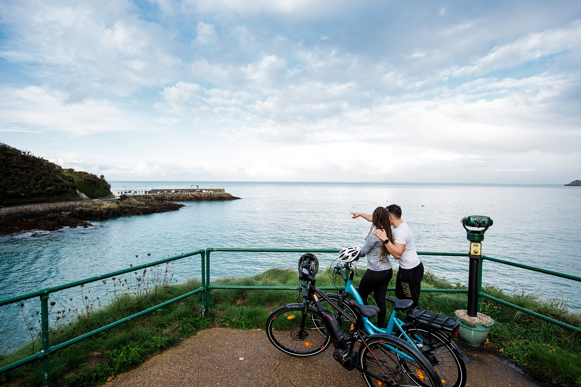 Two cyclists on electric bikes at Bouley Bay.