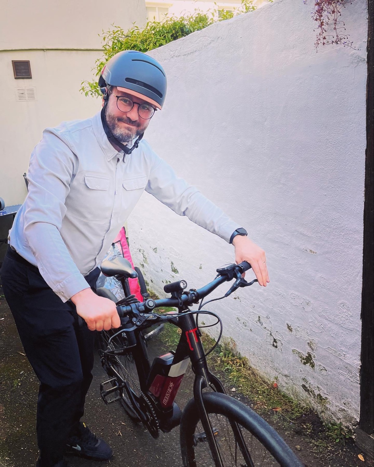 Gavin Murphy, Head of Retail, Powerhouse standing with his electric push bike