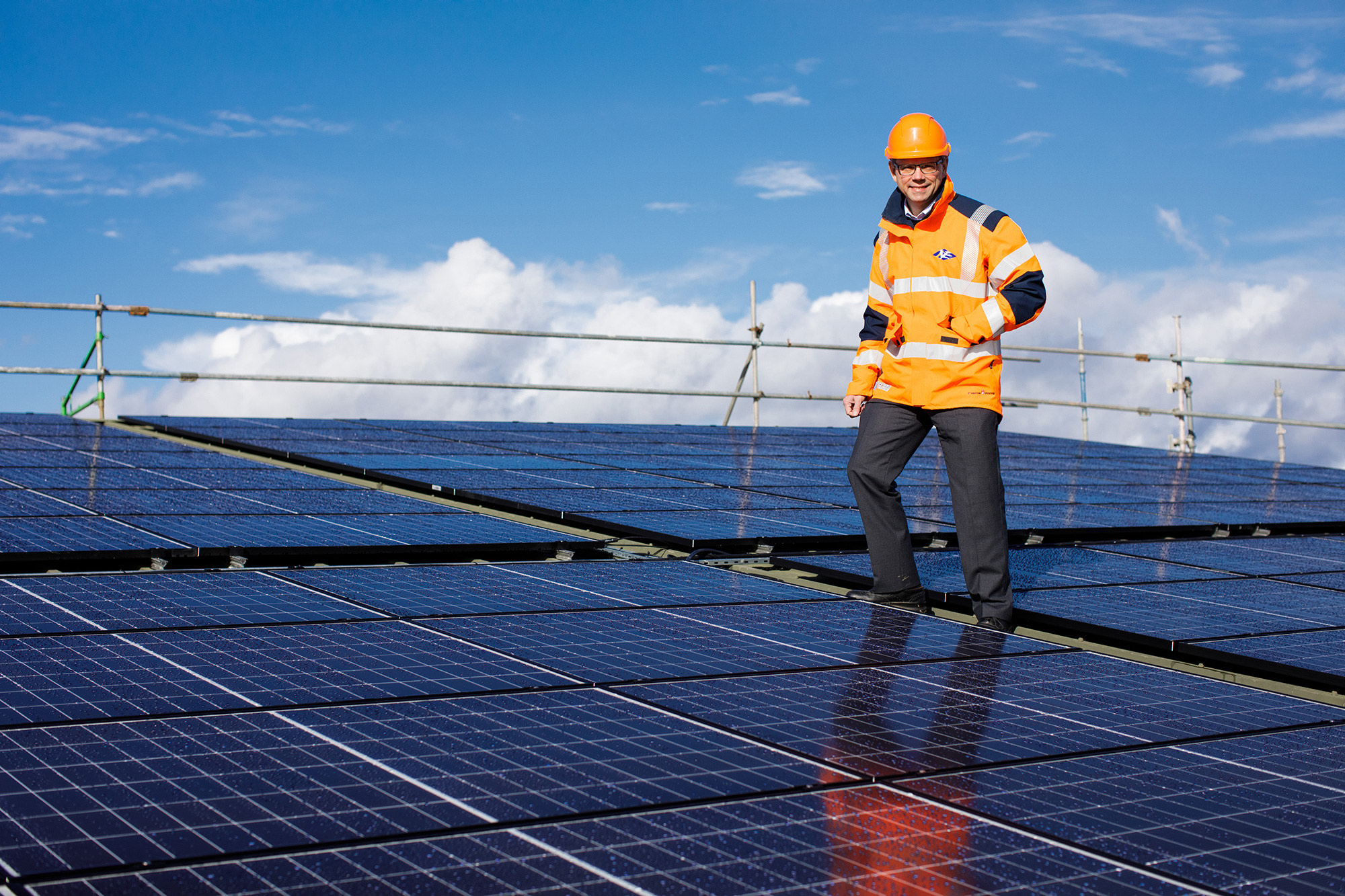 Chris Ambler, Jersey Electricity's CEO, stands on the roof at Jersey Dairy.