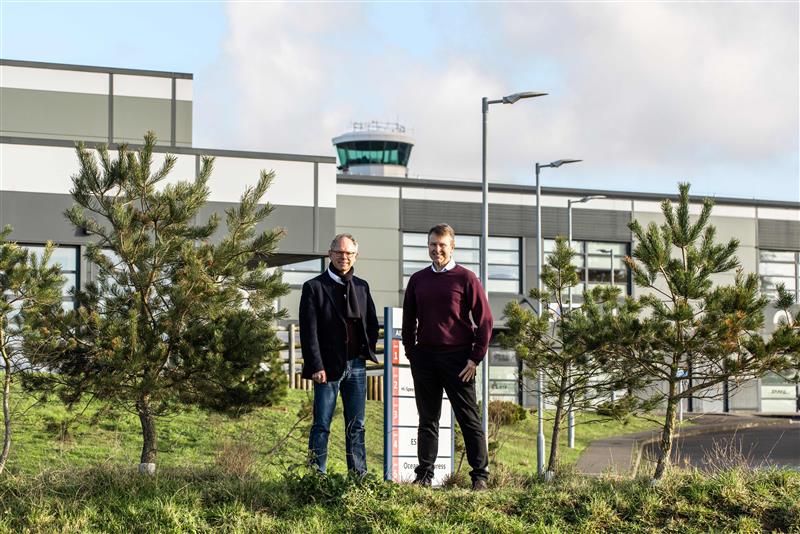 Chris Ambler, CEO at JE, and Matt Thomas, CEO at Ports of Jersey, stood amongst greenery outside of Jersey Airport