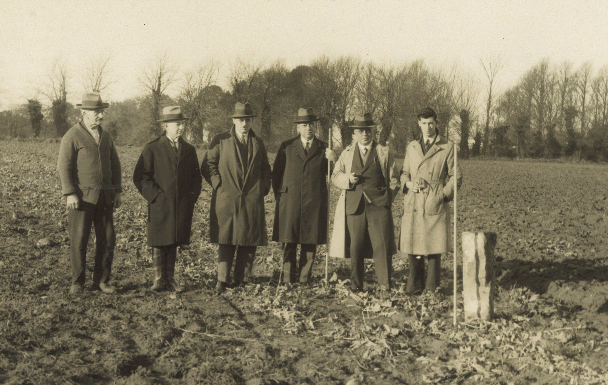 Jersey Electricity executives stand next to the boundary stone that marks the site the Powerhouse now stands on.