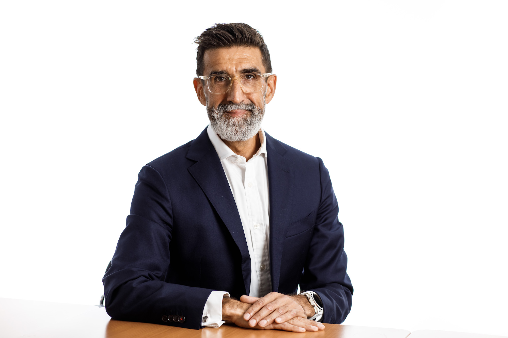 Andrew Welsby sitting at a table wearing a dark blazer and white shirt