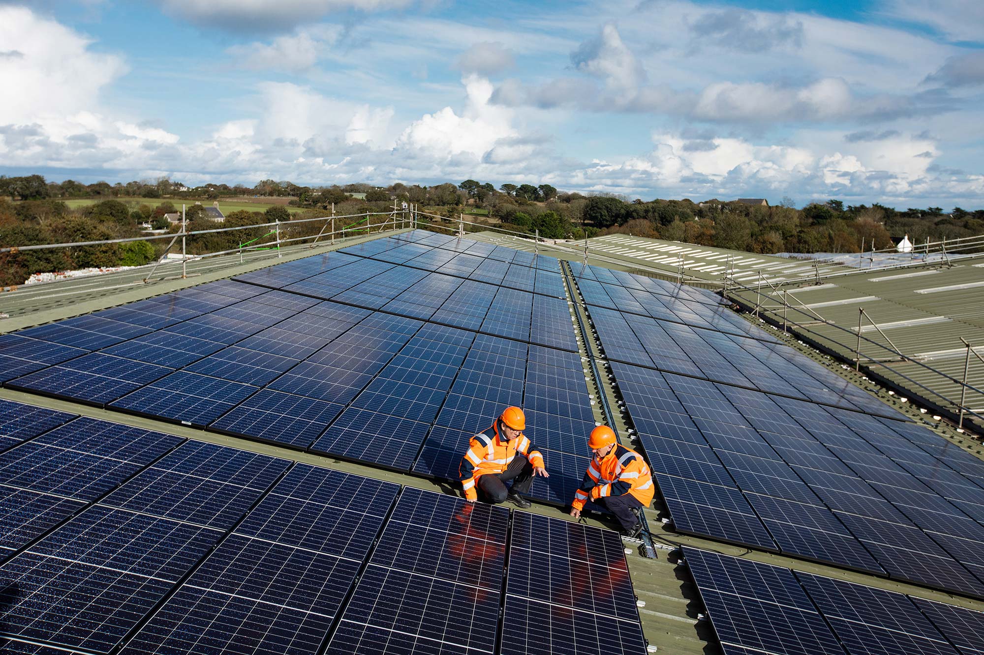 Two Jersey Electrcity team members inspect the Solar PV array installation at Woodside Farm.