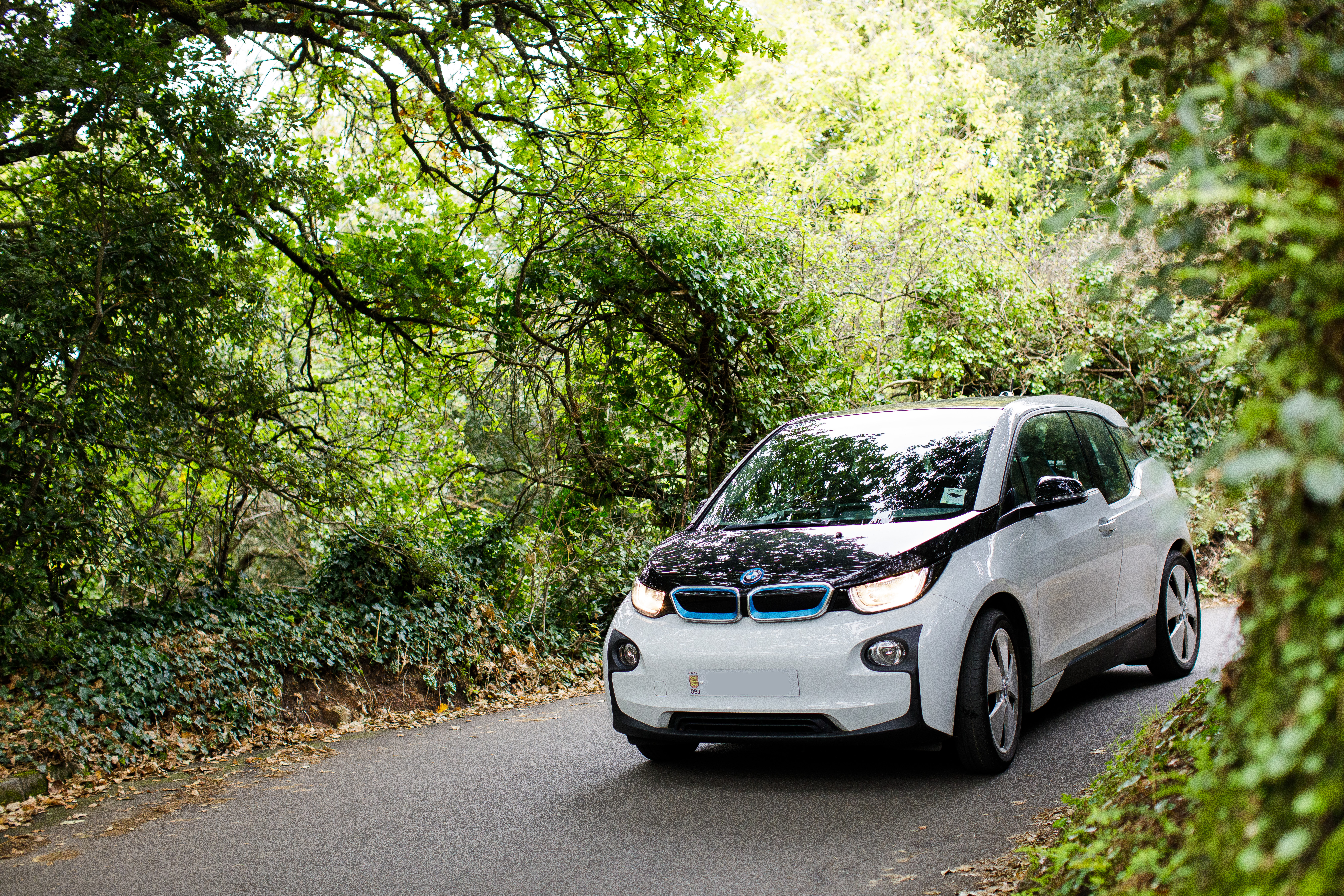 A BMW I3 driving in a country lane