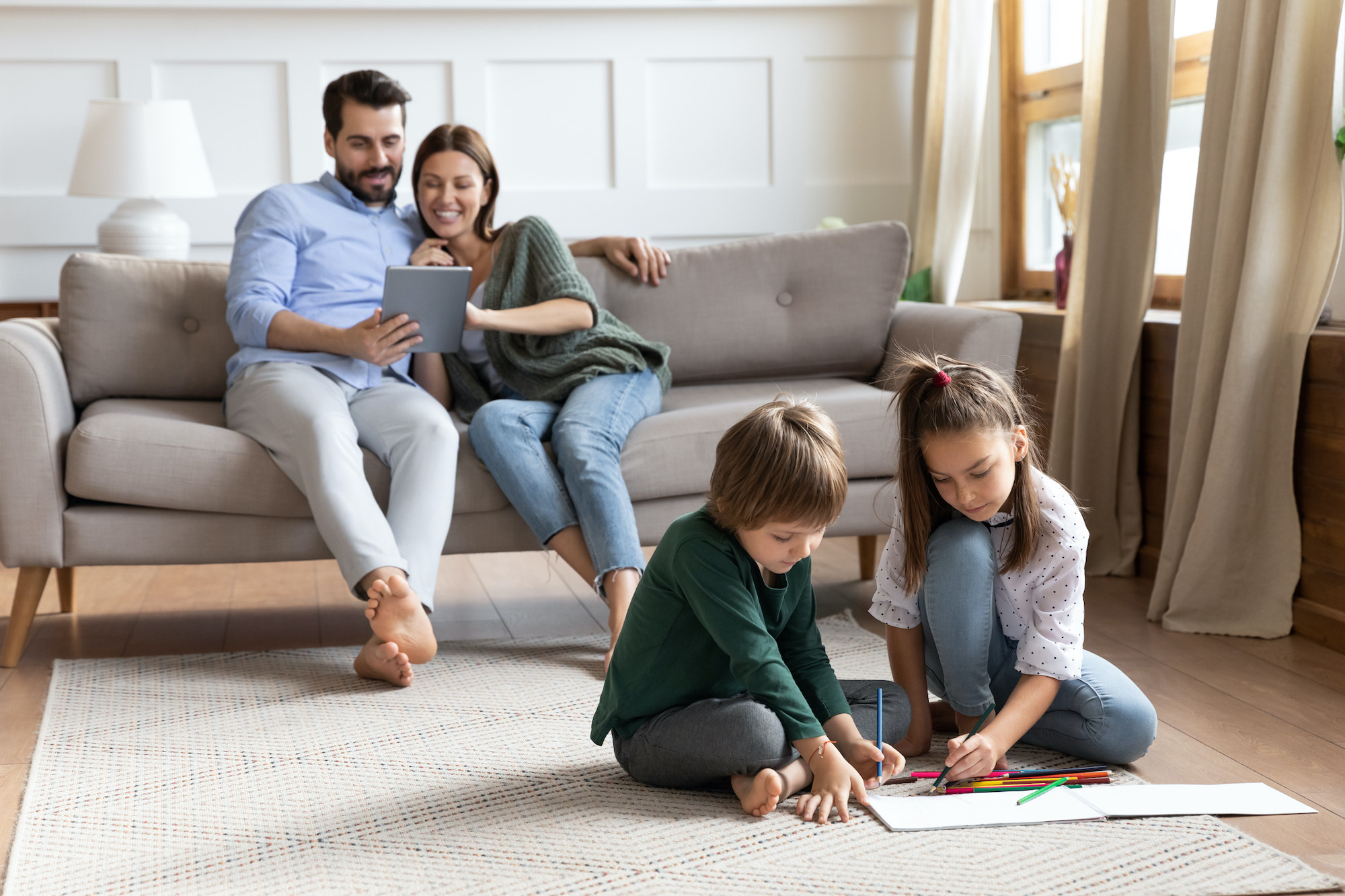 Family of four relaxing in comfy living room